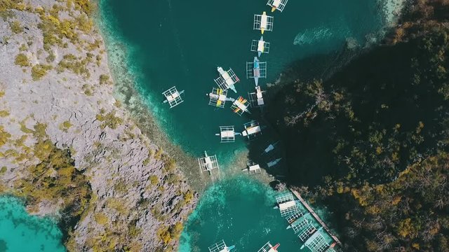bangka boats docket at a small dock between islands