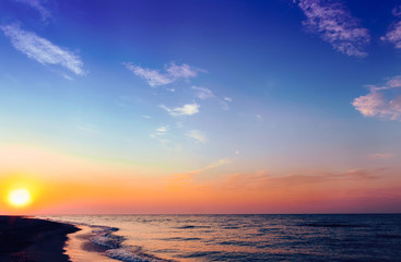Naklejka na ściany i meble Beautiful sky at sunrise on the beach