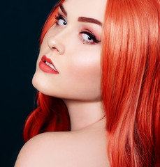 Fototapeta premium Gorgeous red hair profile girl model. Hair Care, perfect Orange color hair. Beautiful hair is shiny, long straight curls. professional red makeup. Color hair.