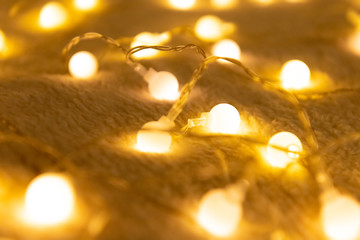 Christmas garland lights from LED bulbs on the carpet background .