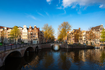 Canals of Amsterdam during sunset in Netherlands. Amsterdam is the capital and most populous city of the Netherlands. Landscape and culture travel, or historical building and sightseeing concept.
