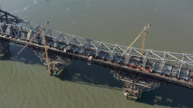 Hercilio Luz Bridge under construction works with huge cranes, aerial shot