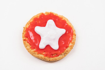 Christmas cookie decorated with royal icing sugar. Cookie decorated with red color and white star on it. Christmas cookie icing.  White background.