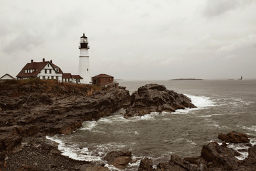 Fototapeta na wymiar Portland Head Lighthouse on a cold and stormy Fall day in Cape Elizabeth, Maine, USA.