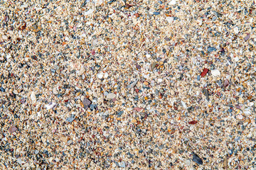 Colorful small pebbles or stone rock at sand beach of sea.