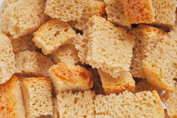 The surface of fresh homemade crackers. Light yellow warm background or wallpaper from food. View from above. Reduced contrast. Macro