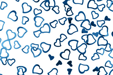 Valentines decoration of little blue confetti hearts on white background. Festive concept.