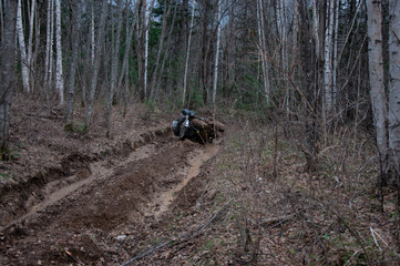 A quad bike in difficult conditions while traveling.