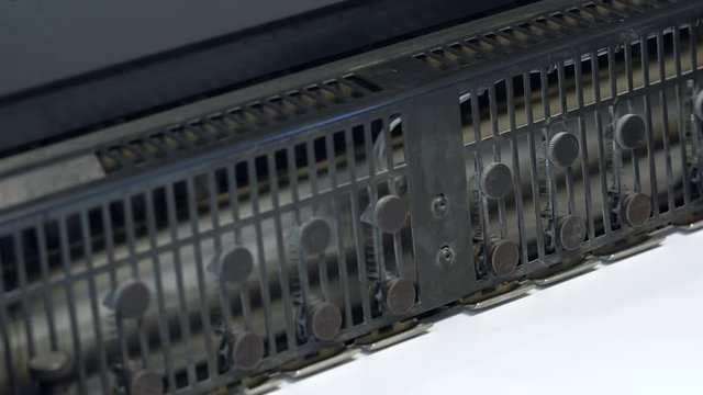 Printed sheets of paper are served in the printing press