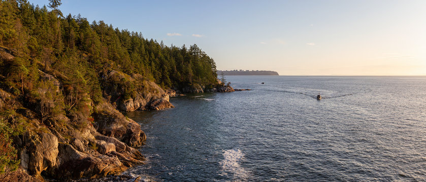 Panoramic View of Rocky Coast in Lighthouse Park, West Vancouver, British Columbia, Canada, with UBC in background. Taken during a cloudy sunset.