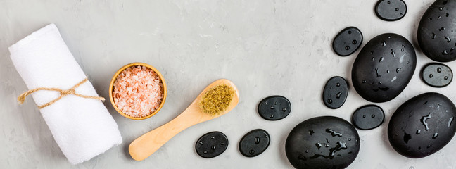 Top view of hot spa stones set for massage treatment on gray concrete background with copy space. Elegant and luxury spa. Flat lay, overhead, mock up, template. Health and beauty care concept