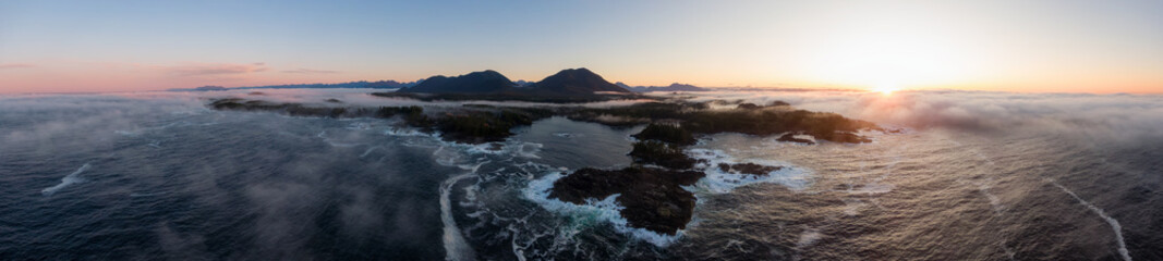 Fototapeta na wymiar Ucluelet, Vancouver Island, British Columbia, Canada. Aerial Panoramic View of a Small Town near Tofino on a Rocky Pacific Ocean Coast during a cloudy and colorful morning sunrise.