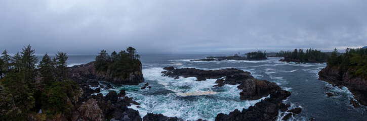 Ucluelet, Vancouver Island, British Columbia, Canada. Aerial Panoramic View of a Small Town near Tofino on a Rocky Pacific Ocean Coast during a cloudy sunrise.