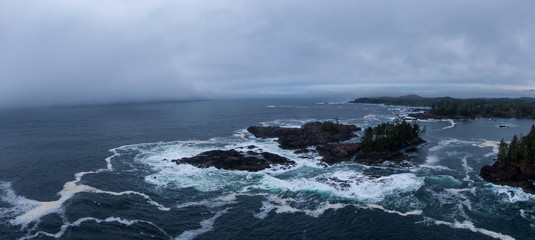 Ucluelet, Vancouver Island, British Columbia, Canada. Aerial Panoramic View of a Small Town near Tofino on a Rocky Pacific Ocean Coast during a cloudy sunrise.