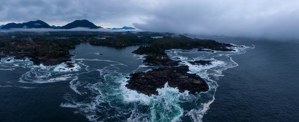 Ucluelet, Vancouver Island, British Columbia, Canada. Aerial Panoramic View of a Small Town near Tofino on a Rocky Pacific Ocean Coast during a cloudy sunrise.