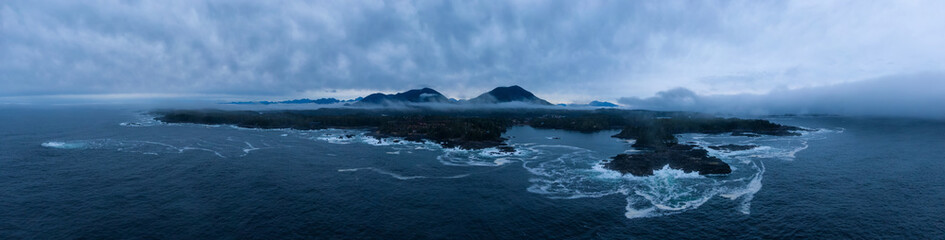 Ucluelet, Vancouver Island, British Columbia, Canada. Aerial Panoramic View of a Small Town near Tofino on a Rocky Pacific Ocean Coast during a cloudy sunrise.