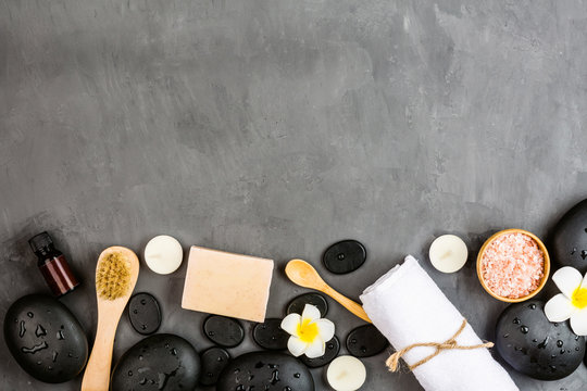 Top View Of Hot Spa Stones Set For Massage Treatment On Gray Concrete Background With Copy Space. Elegant And Luxury Spa. Flat Lay, Overhead, Mock Up, Template. Health And Beauty Care Concept