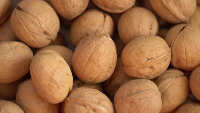 Walnut close up. product rich in minerals and vitamins. Walnut turns in a shot. Walnut kernels rotating. walnut close up lies under beams of the sun. Macro