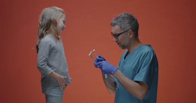 Doctor examining girl with stethoscope