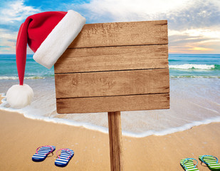 Christmas beach party signboard with two flip-flop pairs