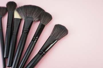 Top view of Professional makeup brushes over black background. Selective focus