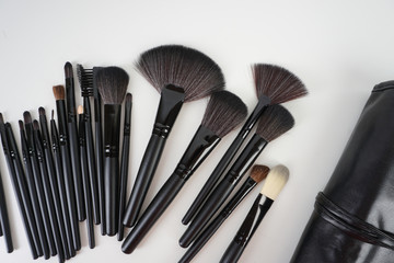 Top view of Professional makeup brushes over black background. Selective focus