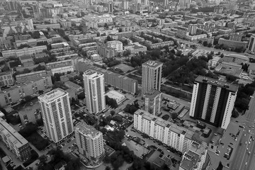 Black and white aerial view in the city with a large number of densely built houses and skyscrapers in the Novosibirsk with infrastructure, transport and traffic. Urban life an environmental problems.