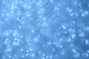 Festive classic blue abstract background with defocused circular bokeh.