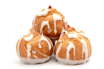 Profitroles with chocolate icing. Closeup of traditional french dessert. Exclusive restaurant snack.