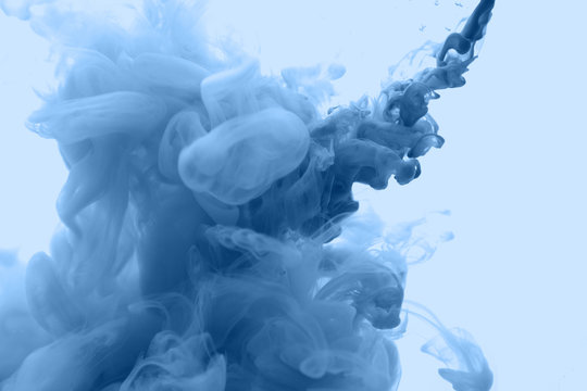 Ink in water in a classic blue color. Look like a cloud or smoke or without gravity.