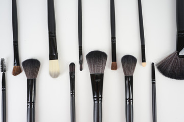 A set of a black make up brushes over the white background