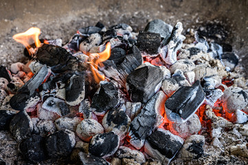 BBQ Grill Pit Glowing And Flaming Hot Charcoal Briquettes coal Food Background Or Texture Close-Up Top View