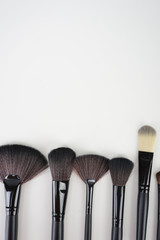 A set of a black make up brushes over the white background