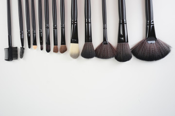 A set of a black make up brushes over the white background