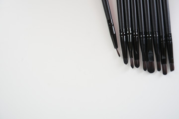 A set of a black make up brushes over the white background