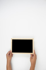 Mens hand holding blackboard over white background. Copy space concept