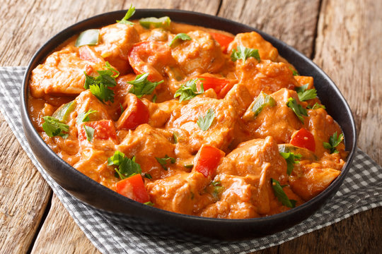 Mafe&nbsp;is a famous and popular West African dish cooked chicken in spicy peanut sauce close-up in a plate. horizontal