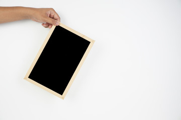 Mens hand holding blackboard over white background. Copy space concept