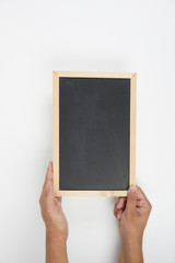 Mens hand holding blackboard over white background. Copy space concept
