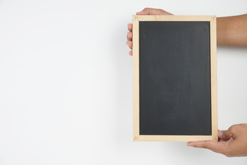 Man holding a clean black board over white background. Copy space on the blackboard