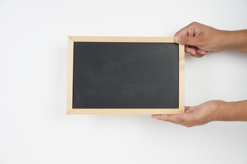 Man holding a clean black board over white background. Copy space on the blackboard