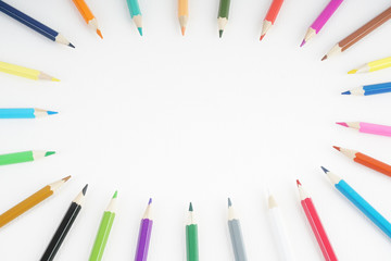 a set of colour pencil perform an oval frame over the white background