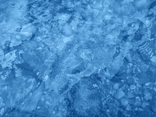 Classic blue color of 2020. Water surface with ripples. Natural background