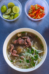 Bowl of Vietnamese Pho beef noodles soup at food vendor