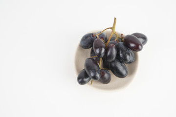 Fresh grape fruits plated over the white background
