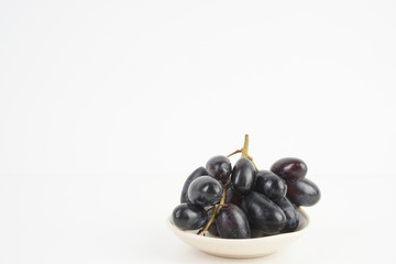 Fresh grape fruits plated over the white background