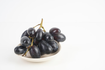 Fresh grape fruits plated over the white background