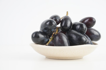 Fresh grape fruits plated over the white background