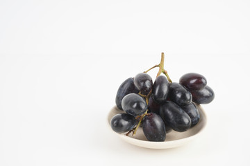 Fresh grape fruits plated over the white background