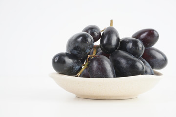Fresh grape fruits plated over the white background